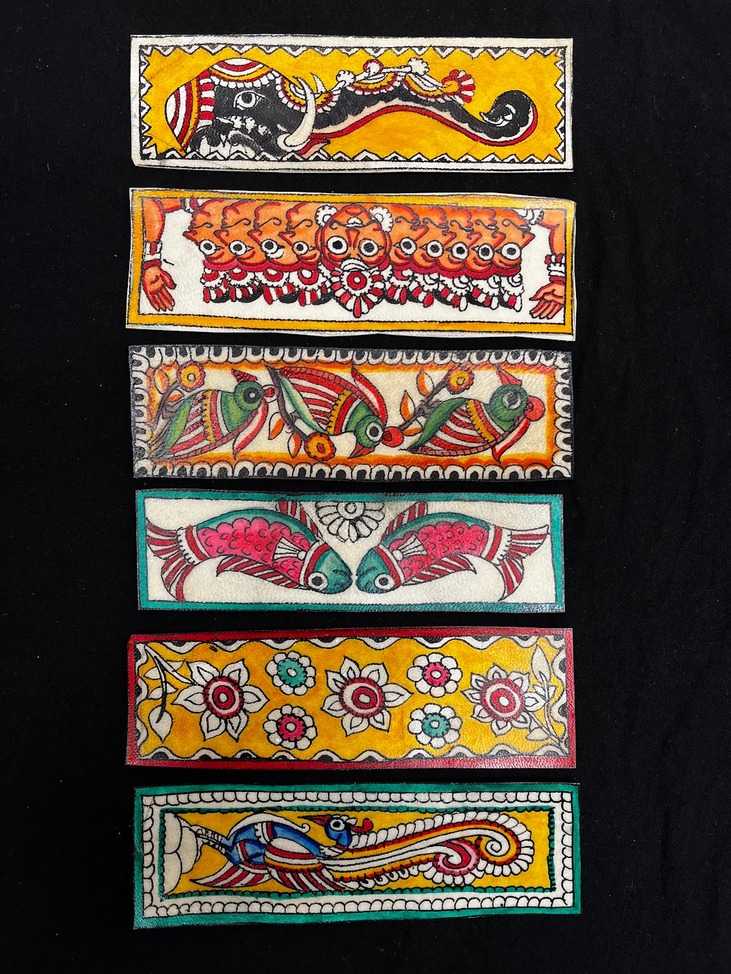Hand-painted leather bookmarks, made using GI-protected Tholu Bommalata craft.